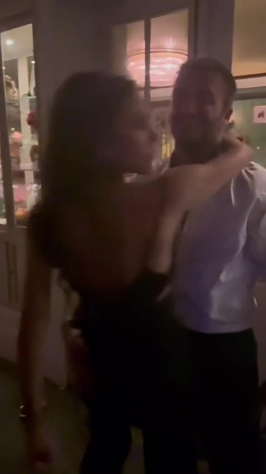Victoria and David Beckham embracing.