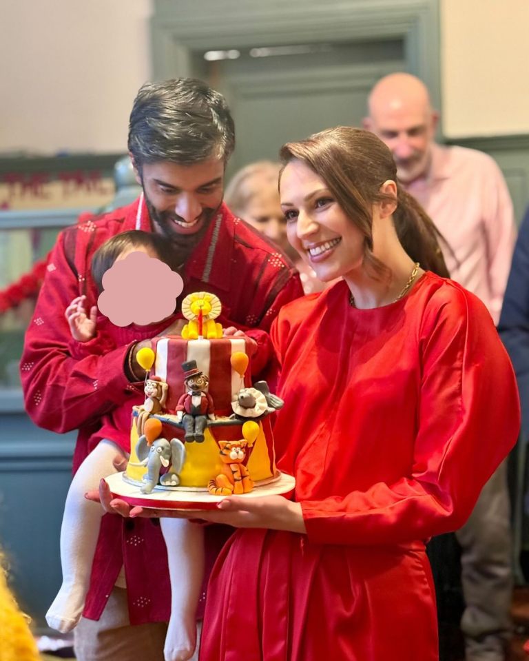 Family holding a circus-themed birthday cake.