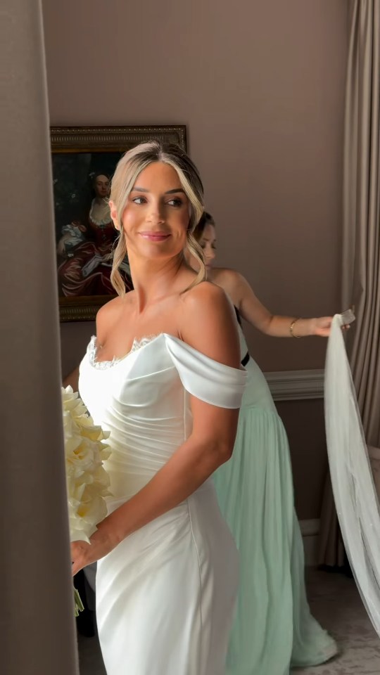 Bride in white wedding dress holding bouquet.
